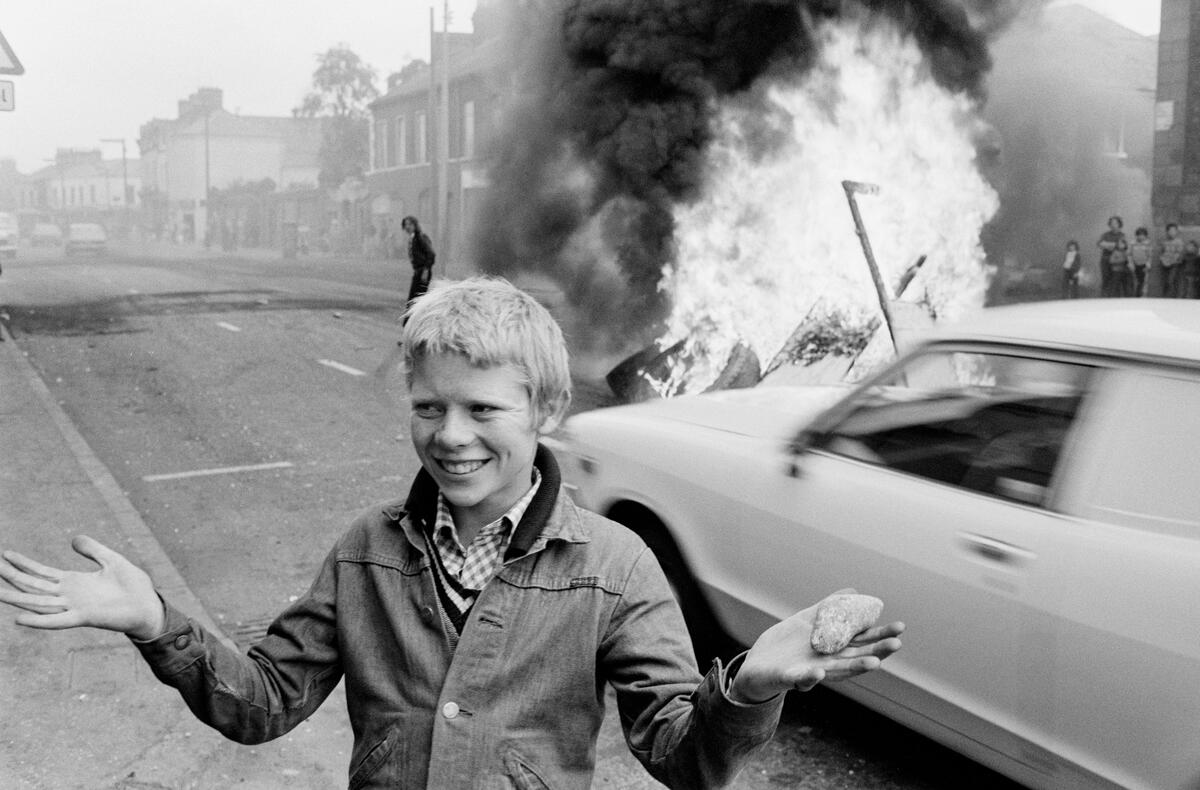 Youth with a stone during a riot at the top of Leeson Street. Catholic Area, West Belfast, Northern Ireland. 1978. © Chris Steele-Perkins - Magnum Photos